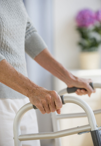 Senior woman using walker.