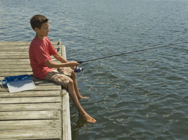 Boy fishing off dock.