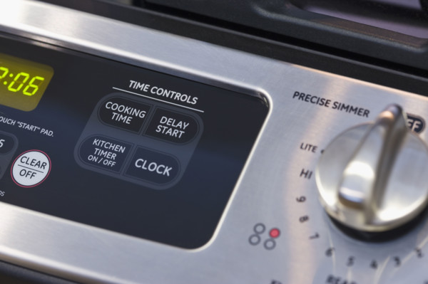 Close up of oven and stove controls.