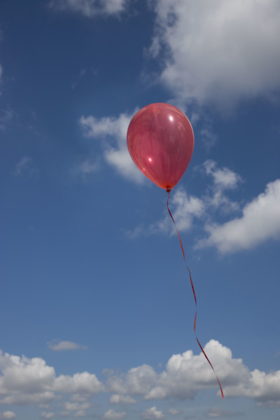 Balloon floating into sky.