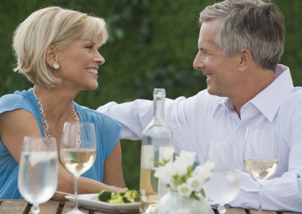 Couple enjoying wine outdoors.