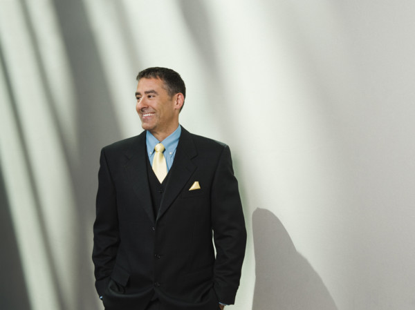 Businessman standing with hands in pockets. Date : 2008
