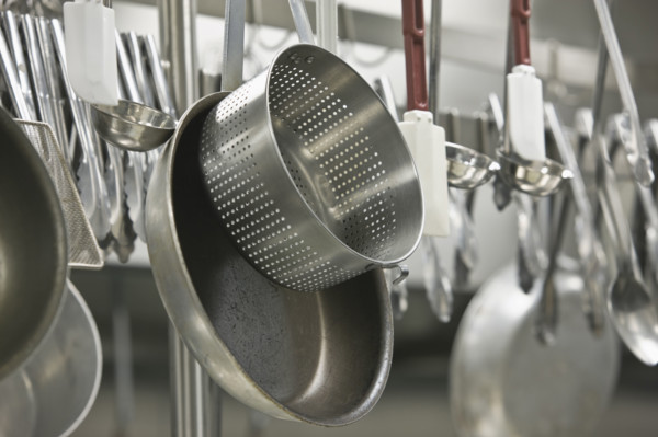 Pots and cooking utensils hanging from rack. Date : 2008