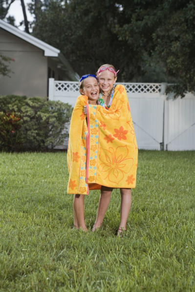 Girls wrapped in towels on lawn. Date : 2008