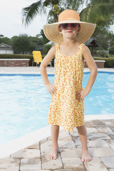 Sassy girl standing at edge of swimming pool. Date : 2008