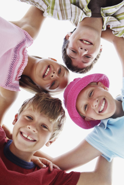 Low angle view of children in a huddle. Date : 2008