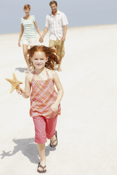 Family walking together on beach. Date : 2008