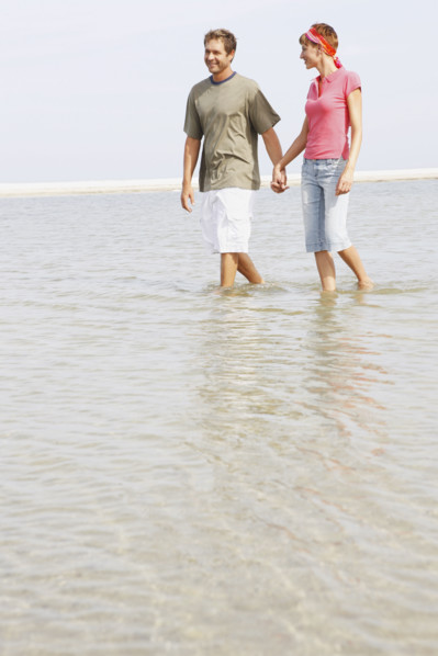 Couple wading in ocean. Date : 2008