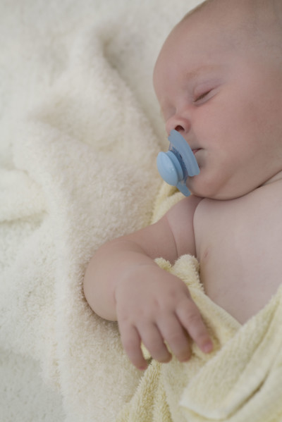 Baby sleeping with pacifier in mouth. Date : 2008