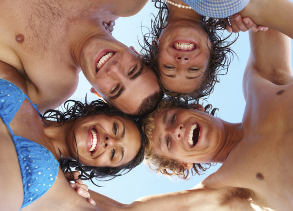 Low angle view of young friends in huddle. Date : 2008