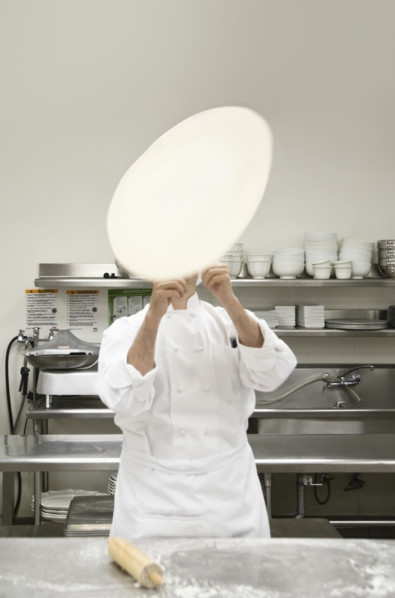 Chef tossing pizza dough. Date : 2008