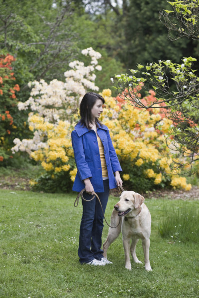 Girl walking dog in park. Date : 2008