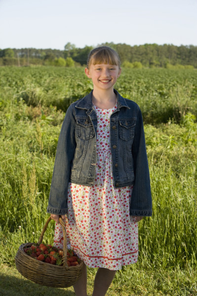 Girl picking strawberries. Date : 2008