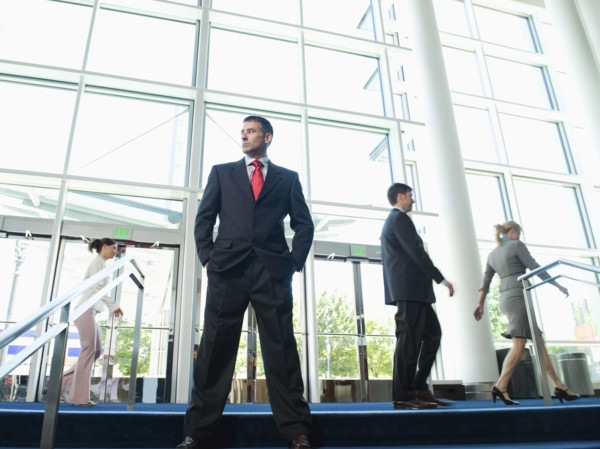 Confident businessman posing in lobby. Date : 2008