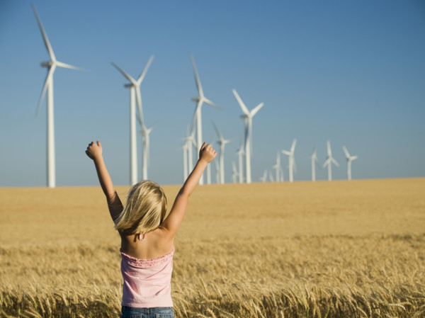 Girl with arms raised on wind farm. Date : 2008