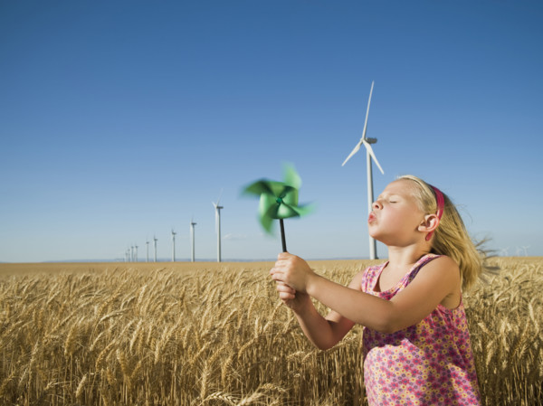 Girl holding pinwheel on wind farm. Date : 2008