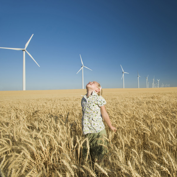 Girl looking to sky on wind farm. Date : 2008