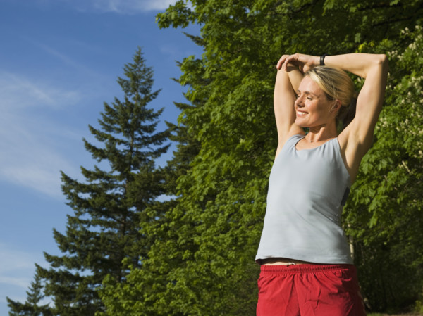 Runner stretching on rocky trail. Date : 2008