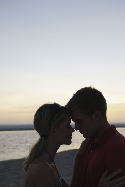 Young couple hugging on beach at sunset. Date : 2008