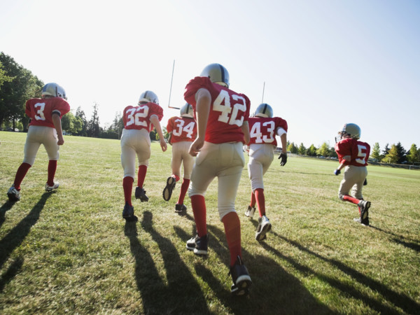 Football players running onto field. Date: 2008