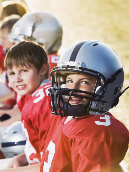 Football players sitting on bench. Date: 2008