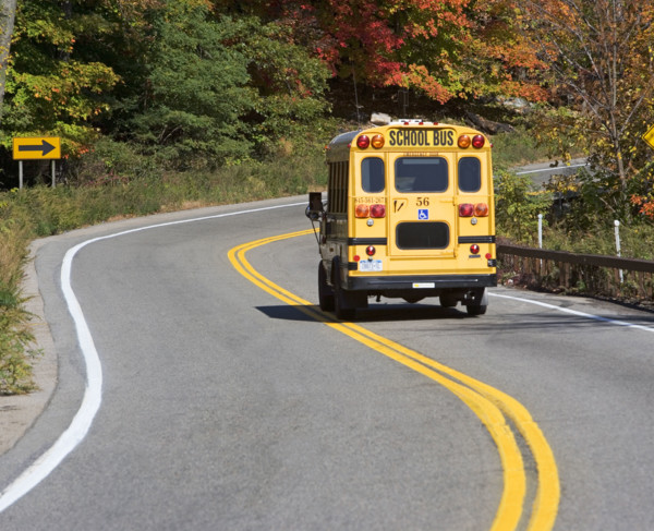 School bus driving down rural road. Date : 2008