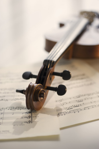 Violin laying on sheet music.
