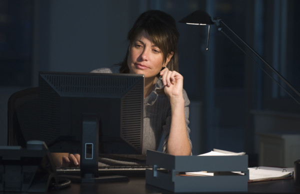Businesswoman working late in office.