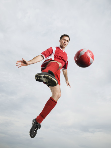 Soccer player kicking soccer ball in mid-air. Date : 2008
