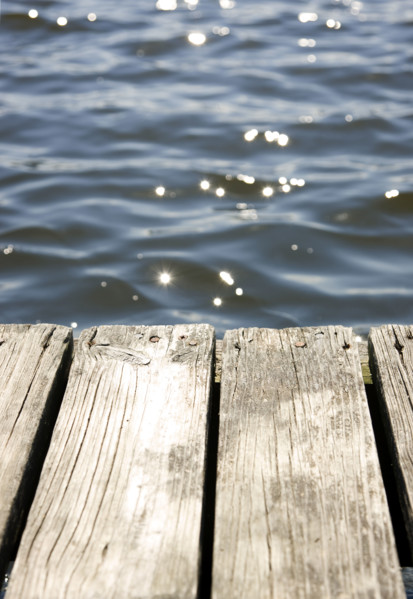 Close up of dock and sun reflecting on lake. Date : 2008