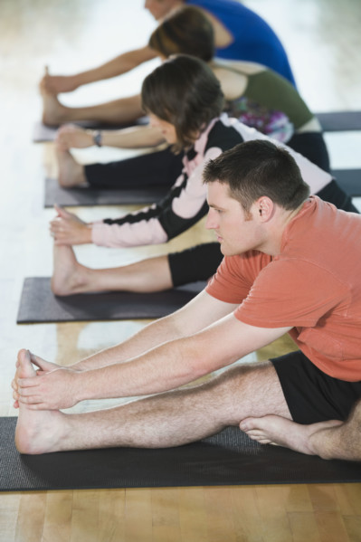 Fitness class stretching on mats. Date: 2008