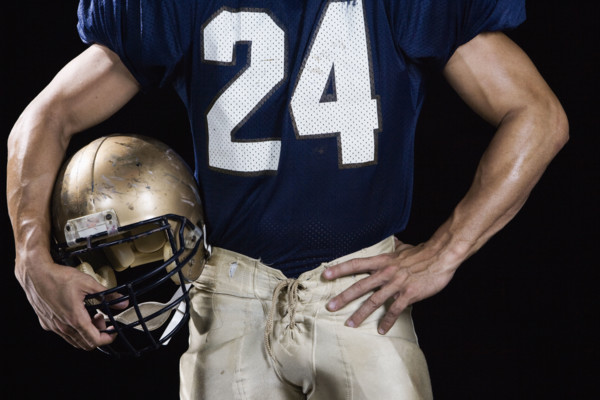 Football player wearing uniform and holding helmet. Date : 2008