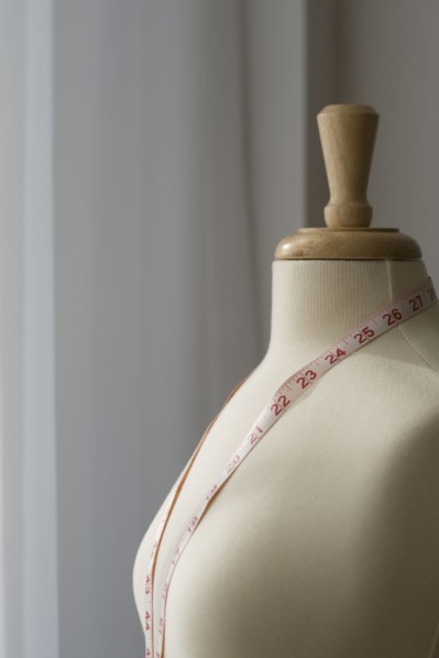 Measuring tape on dressmakers model.