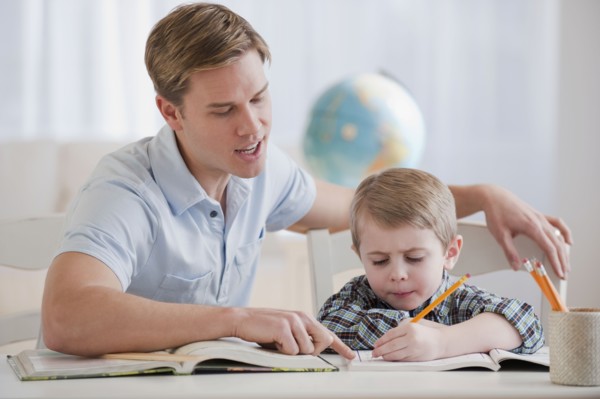 Father helping son with homework.