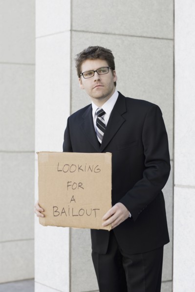 Businessman begging for money. Photographe : PT Images