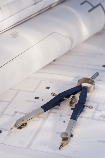 Drawing compass and blueprints. Photographe : Daniel Grill