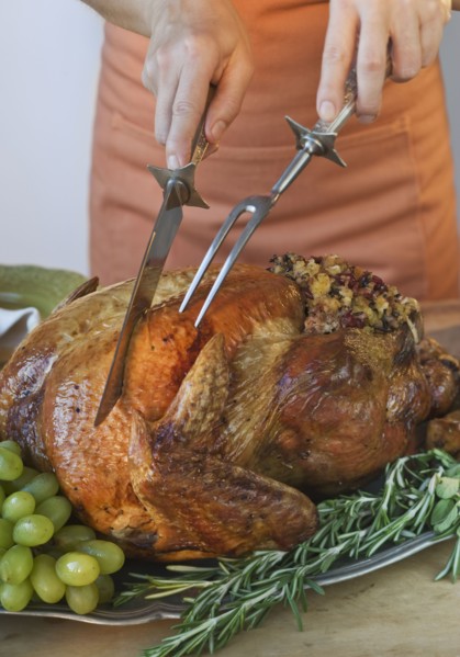 Man carving Thanksgiving turkey.