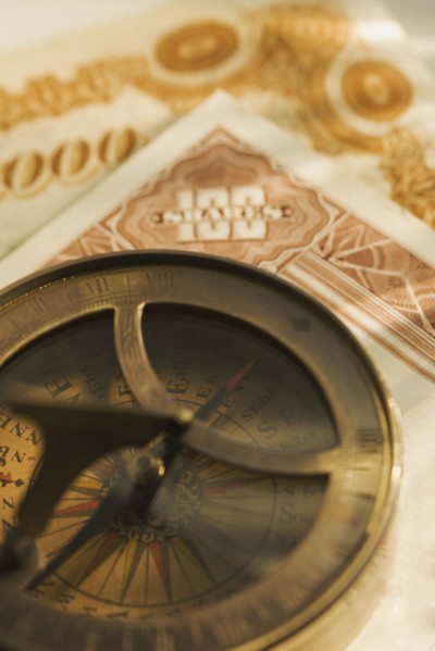 Antique compass and corporate bonds.