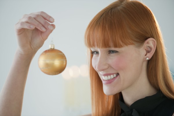 Woman holding Christmas ornament.