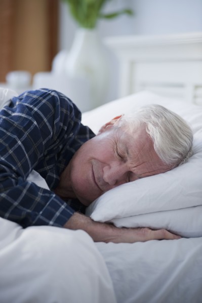 Senior man sleeping in bed.