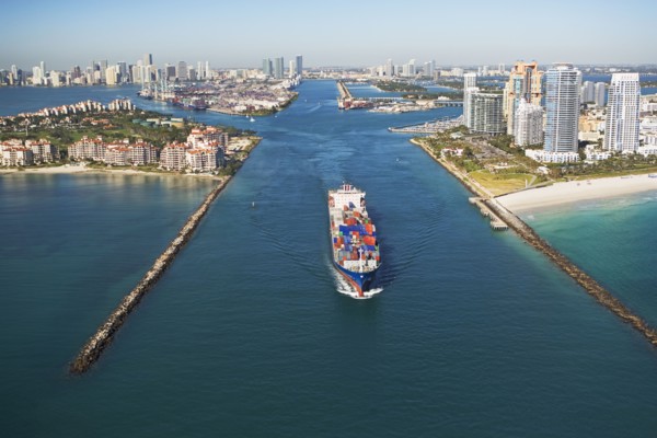 Aerial view of waterfront city and cargo ship. Photographe : fotog