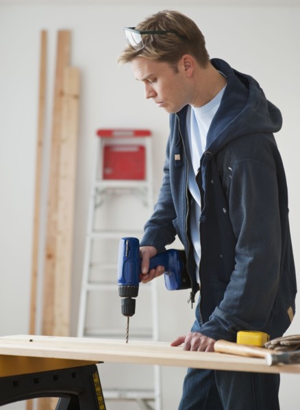 Man drilling on board.