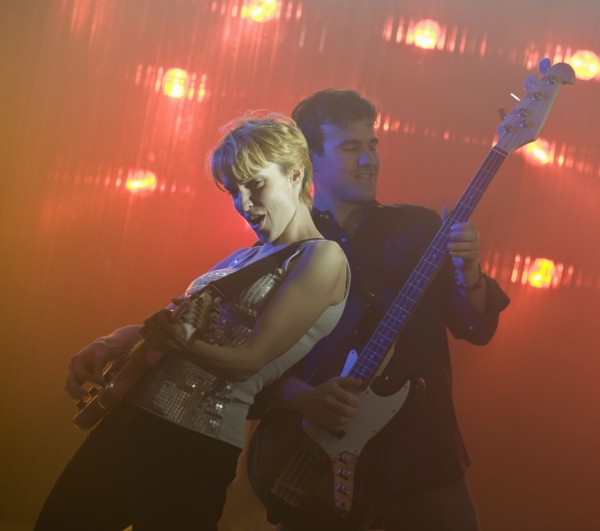 Performers playing electric guitars.