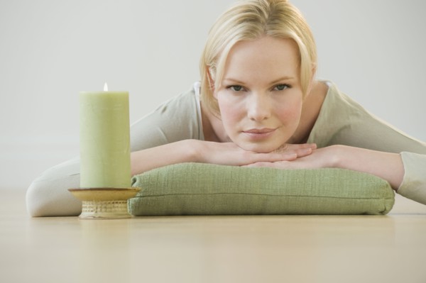 Woman relaxing with candle.