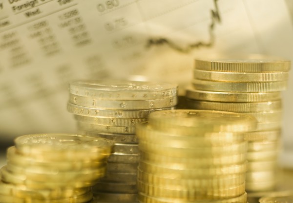 Stacks of euro coins and exchange rates.