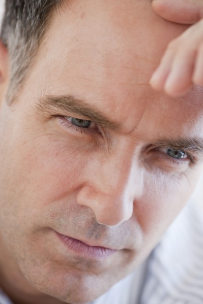 Mature businessman contemplating, close-up.