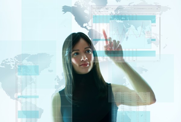 Mid-adult woman pointing on world map.