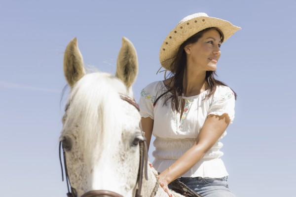 A woman riding a horse