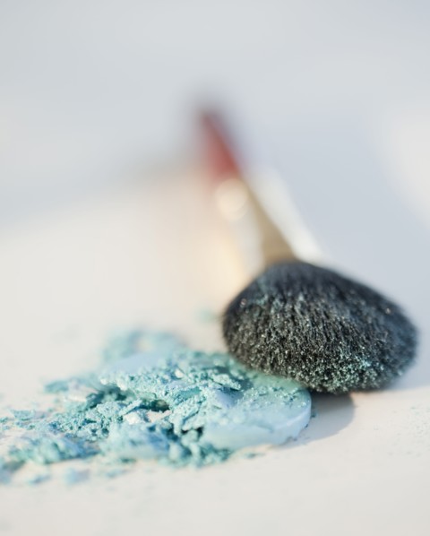Powder beside a make up brush