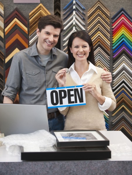 A woman and man at a frame store.